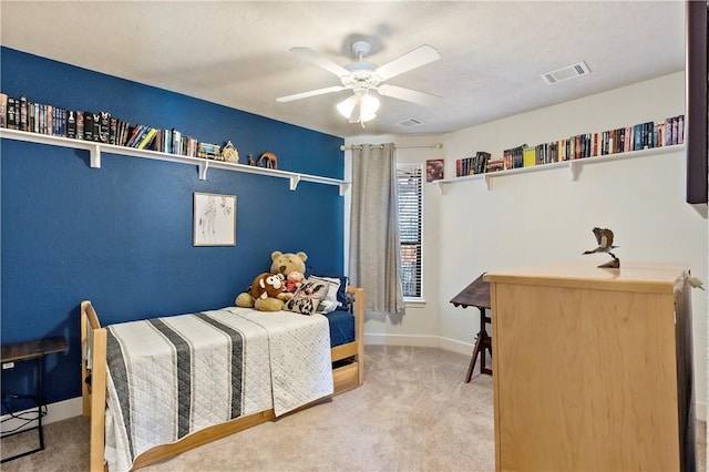 carpeted bedroom featuring visible vents, baseboards, and ceiling fan