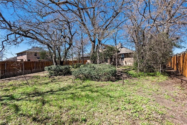 view of yard with a fenced backyard