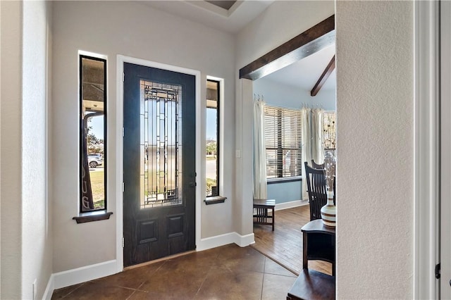 foyer entrance with tile patterned floors and baseboards