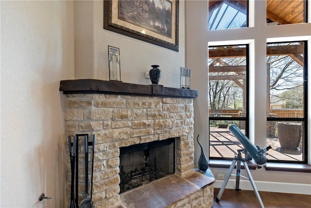 interior details with a stone fireplace and baseboards