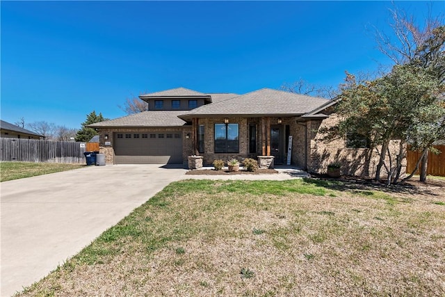 view of front of home with a front yard, an attached garage, fence, and driveway