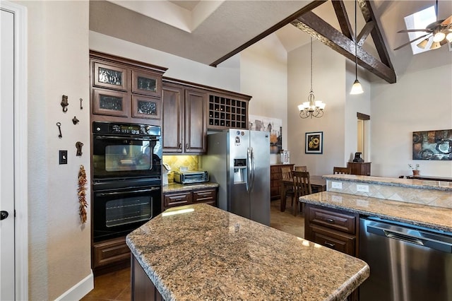 kitchen with light stone counters, a kitchen island, stainless steel appliances, dark brown cabinets, and tasteful backsplash