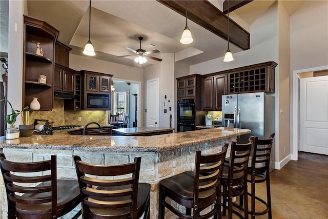 kitchen featuring black appliances, open shelves, tasteful backsplash, a peninsula, and dark brown cabinets