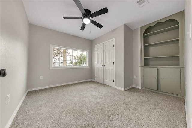 unfurnished bedroom with light colored carpet, a closet, and ceiling fan