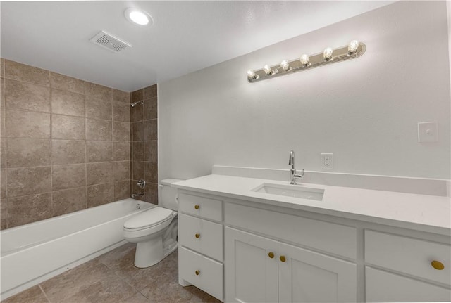 full bathroom featuring vanity, tiled shower / bath, tile patterned floors, and toilet