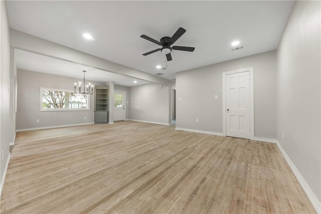 unfurnished living room with ceiling fan with notable chandelier and light wood-type flooring