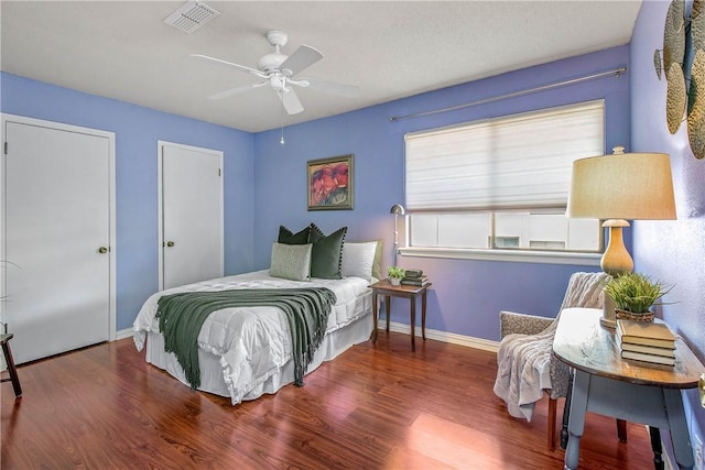 bedroom with ceiling fan and dark hardwood / wood-style flooring