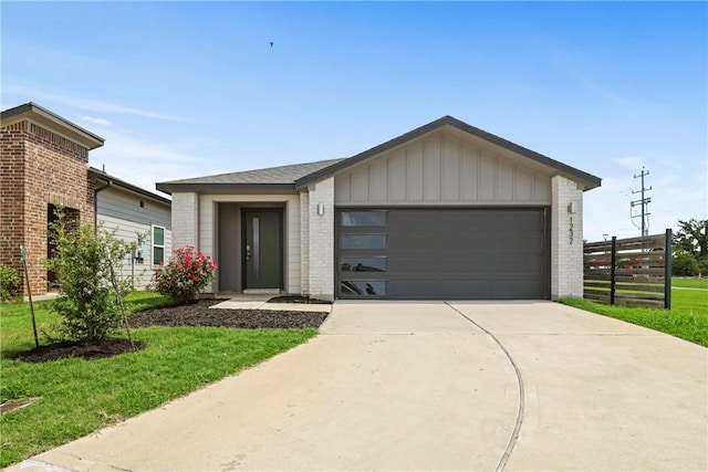 1232 Amistad Loop, College Station, TX 77845 - view of front of property with brick siding, board and batten siding, driveway, and an attached garage