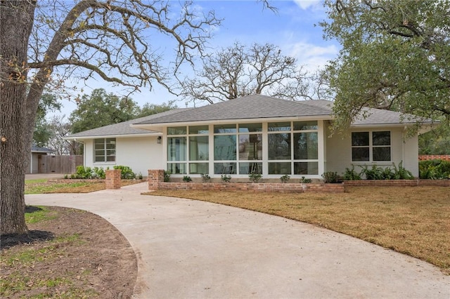 rear view of house featuring a lawn