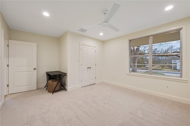 carpeted empty room with ceiling fan