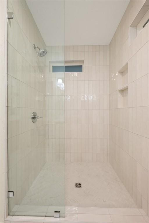 bathroom with a shower with shower door