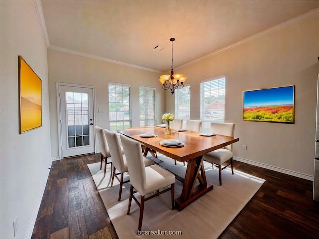 dining area featuring dark wood-type flooring, plenty of natural light, crown molding, and a notable chandelier