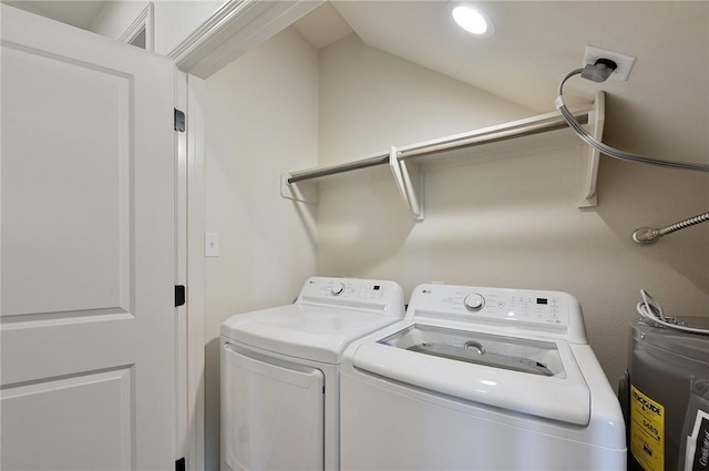 washroom featuring electric water heater and washing machine and dryer