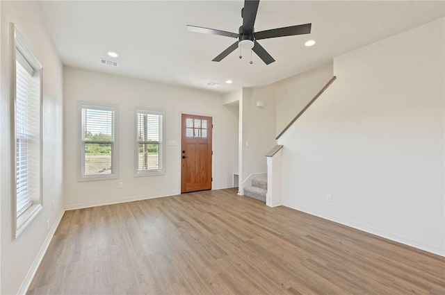 foyer entrance with ceiling fan and light hardwood / wood-style floors