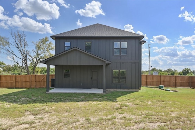 rear view of house with a patio area and a yard