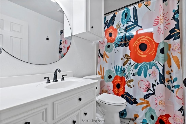 bathroom featuring tile patterned flooring, vanity, and toilet