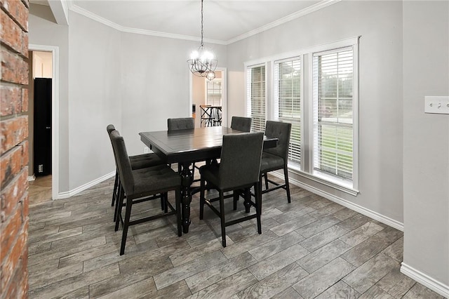 dining area featuring a chandelier, crown molding, and baseboards