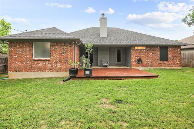 back of house with a deck, a shingled roof, a chimney, and brick siding
