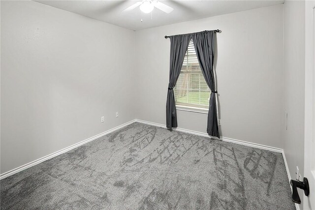 carpeted empty room featuring a ceiling fan and baseboards