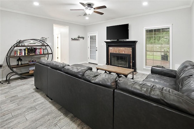 living room featuring a ceiling fan, light wood-style floors, recessed lighting, baseboards, and a brick fireplace