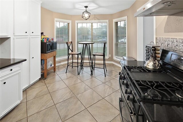 dining space with light tile patterned floors and baseboards