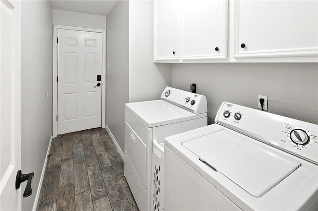 washroom with washer and clothes dryer, cabinet space, dark wood-style flooring, and baseboards