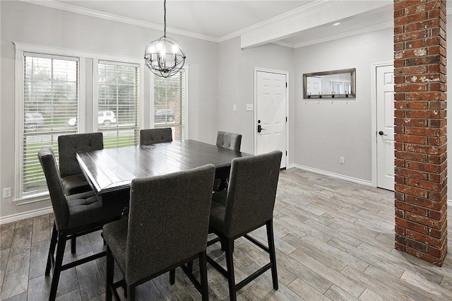 dining room featuring a chandelier, light wood-style floors, baseboards, and crown molding