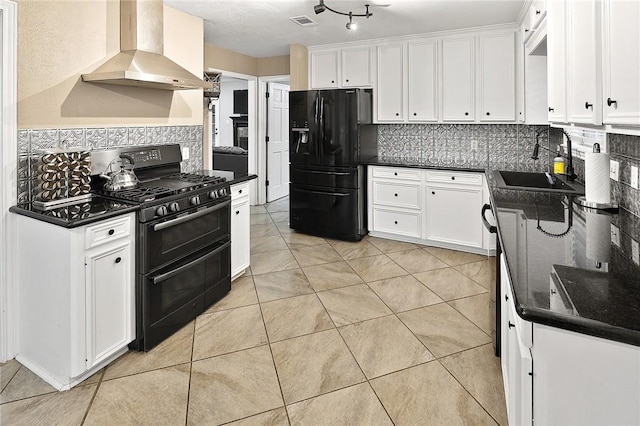 kitchen with black appliances, wall chimney exhaust hood, decorative backsplash, a sink, and white cabinetry