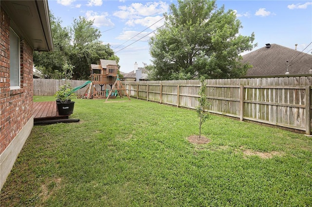 view of yard with a playground and a deck
