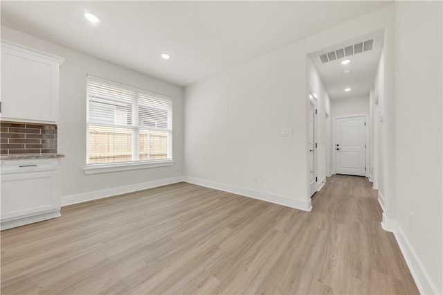 unfurnished living room featuring light hardwood / wood-style flooring