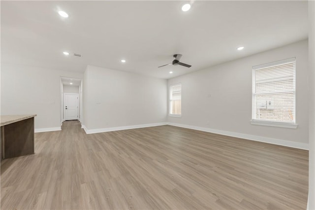 spare room with ceiling fan and light hardwood / wood-style floors