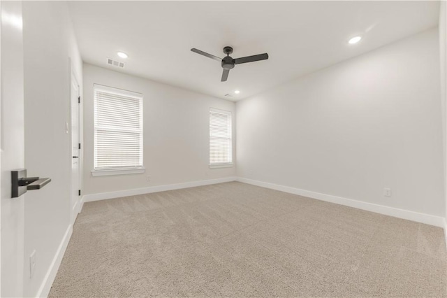 carpeted empty room featuring ceiling fan