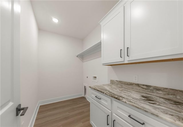 washroom featuring cabinets, hookup for a washing machine, hookup for an electric dryer, and light wood-type flooring