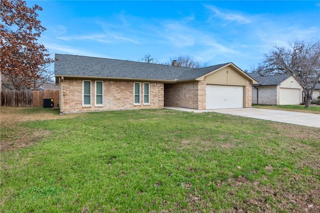 single story home featuring a garage, central AC, and a front lawn