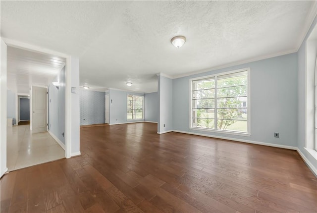 714 S Rosemary Dr, Bryan, TX 77802 - empty room featuring wood finished floors, a textured ceiling, and ornamental molding