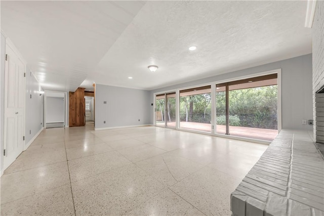 714 S Rosemary Dr, Bryan, TX 77802 - unfurnished living room featuring dark aggregate flooring, plenty of natural light, and recessed lighting