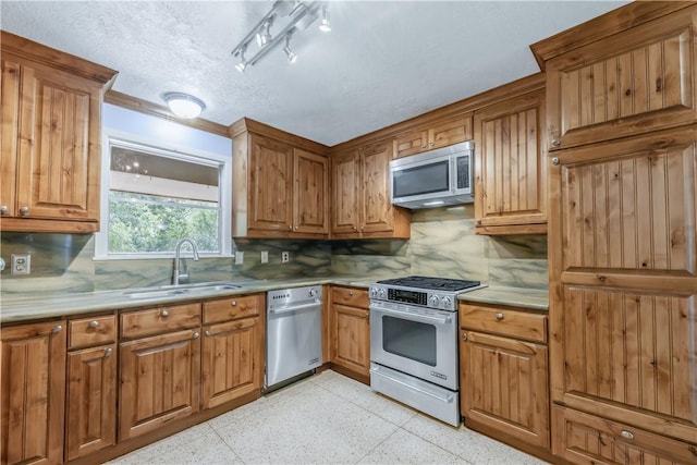714 S Rosemary Dr, Bryan, TX 77802 - kitchen with stainless steel appliances, backsplash, dark speckled floor, and a textured ceiling