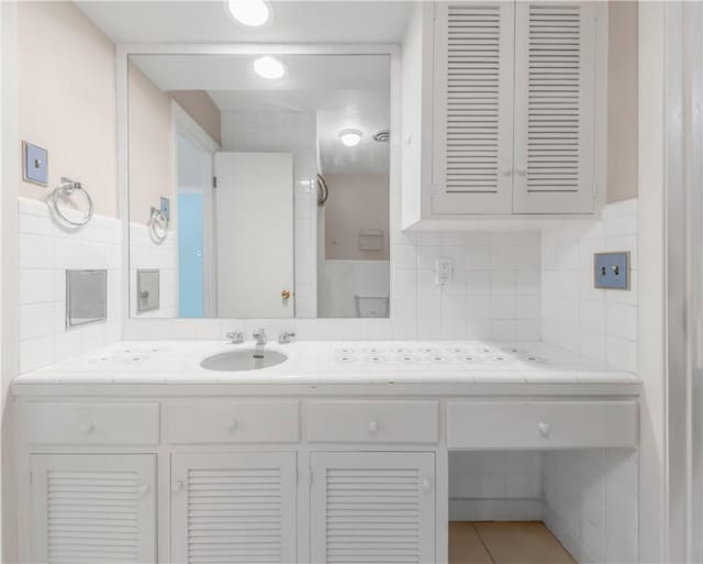 714 S Rosemary Dr, Bryan, TX 77802 - bathroom featuring vanity, tasteful backsplash, and tile patterned flooring