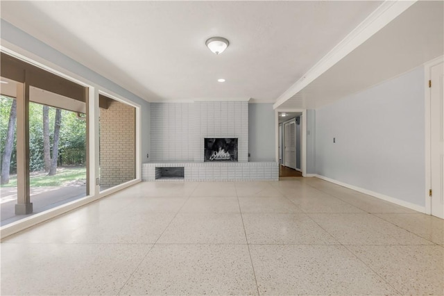 714 S Rosemary Dr, Bryan, TX 77802 - unfurnished living room with crown molding and a brick fireplace