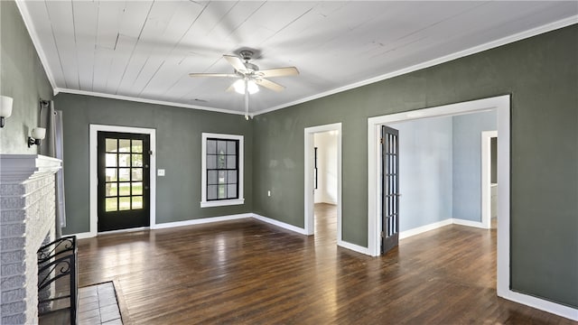 entrance foyer featuring a ceiling fan, wood finished floors, a fireplace, ornamental molding, and baseboards