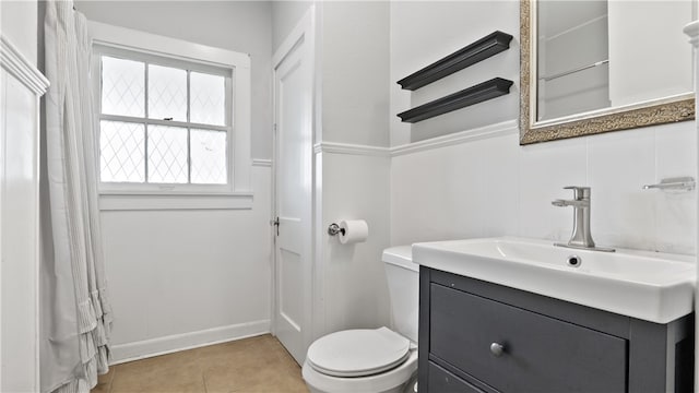 full bathroom with toilet, tile patterned flooring, and vanity