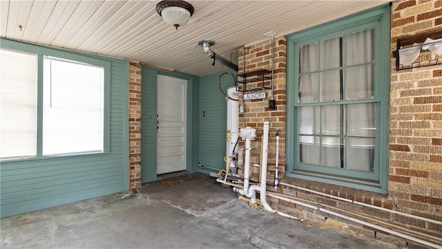 doorway to property with brick siding