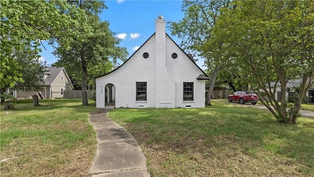 view of front facade with a chimney and brick siding