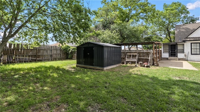 view of yard featuring a patio area, a storage unit, and an outdoor structure