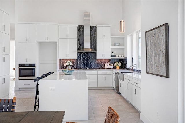 kitchen featuring a center island, pendant lighting, white cabinetry, and appliances with stainless steel finishes