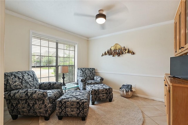 sitting room with ceiling fan, ornamental molding, and light tile patterned flooring