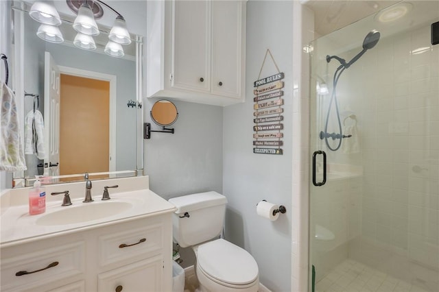 bathroom with toilet, walk in shower, and vanity