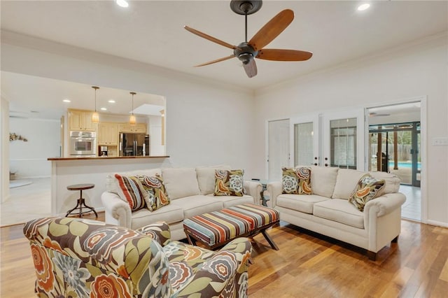 living room featuring ceiling fan, crown molding, light hardwood / wood-style flooring, and french doors