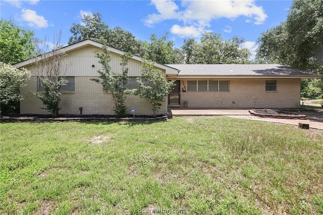 rear view of house with a lawn and a patio area