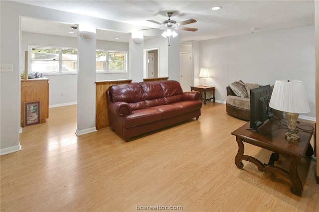 living room with ceiling fan and light hardwood / wood-style floors